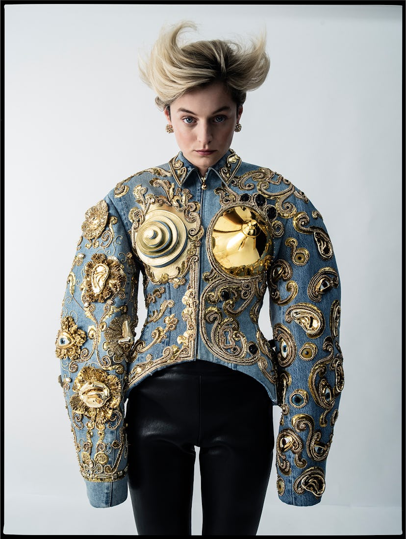 Emma Corrin wearing a gold cone bra top jacket