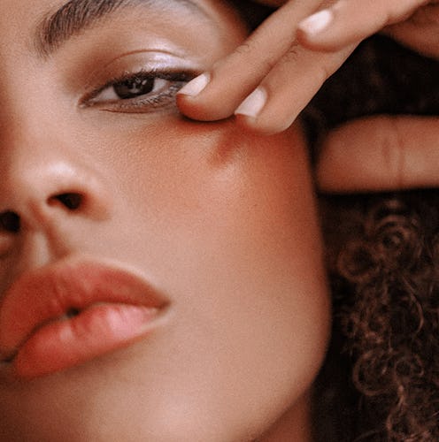 A close up of a model posing with Victoria Beckham's New Posh & Bitten Lip Tint Colours