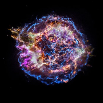 An orb filled with many colorful strands and rings. This is the remnant of a supernova, and it is ca...