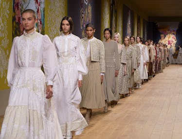 A line of models walking down the runway at the end of the Dior couture show