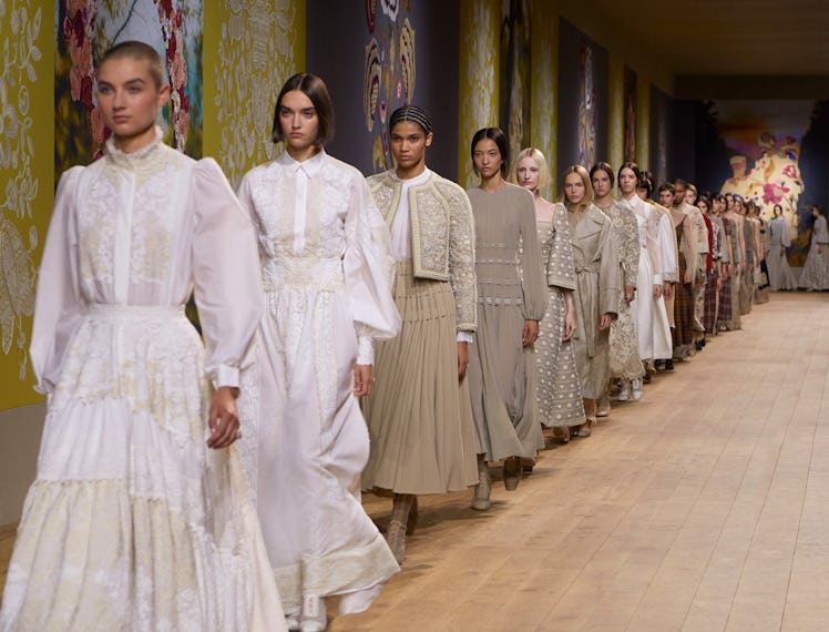 A line of models walking down the runway at the end of the Dior couture show