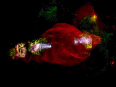 A red cloud of gas in space, with multicolored jets shooting out two ends of it, in the Manatee Nebu...