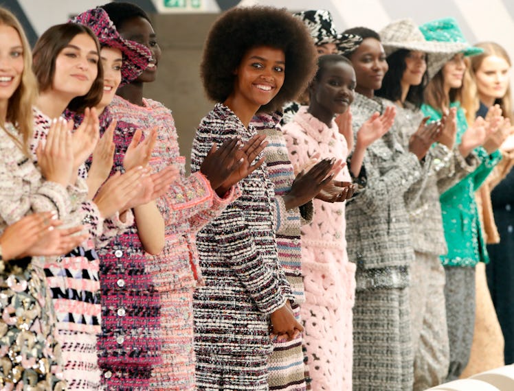 A photo of Chanel models clapping at the end of the Fall 2022 Couture show