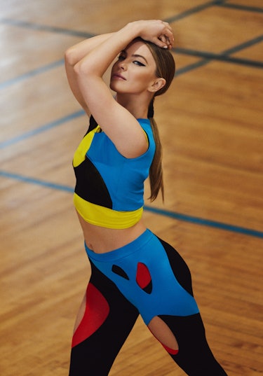 The dancer in blue, red, yellow and black leggings and top by Loewe 