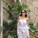 Dua Lipa in a white lacy dress