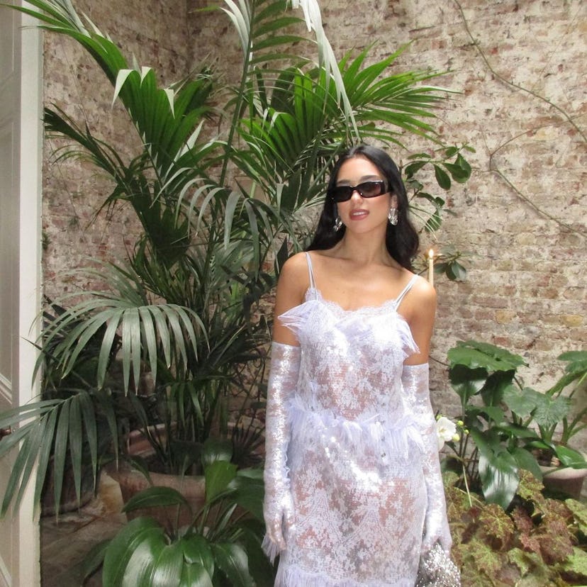 Dua Lipa in a white lacy dress