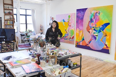 Ilana standing in her studio amongst her paints and other tools