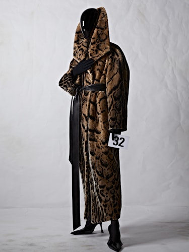 A model in a long animal print Balenciaga robe with a black plexiglass face shield