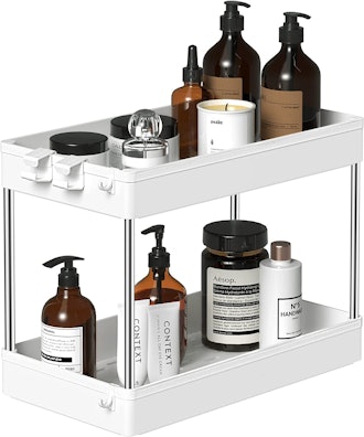 2-tier under sink organizer in white with products atop it