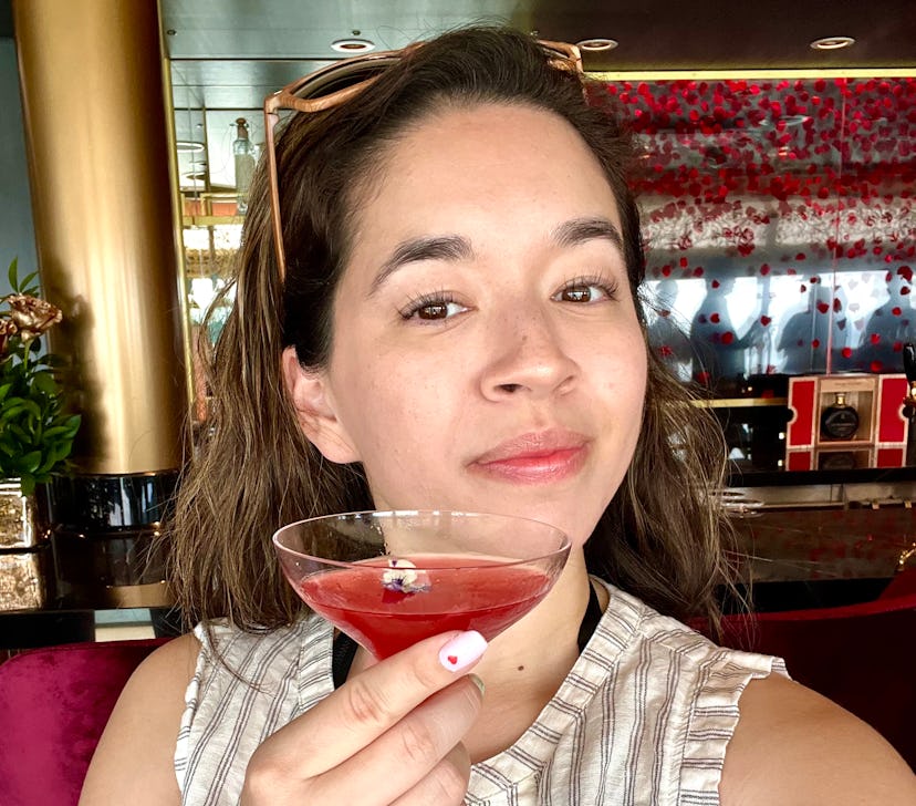 Elite Daily Deputy Editor Kaitlin Cubria having a cocktail on Disney Cruise Line's Disney Wish.