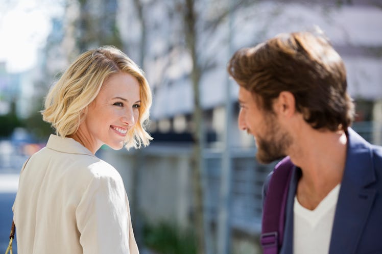 A woman smiles at a married man.