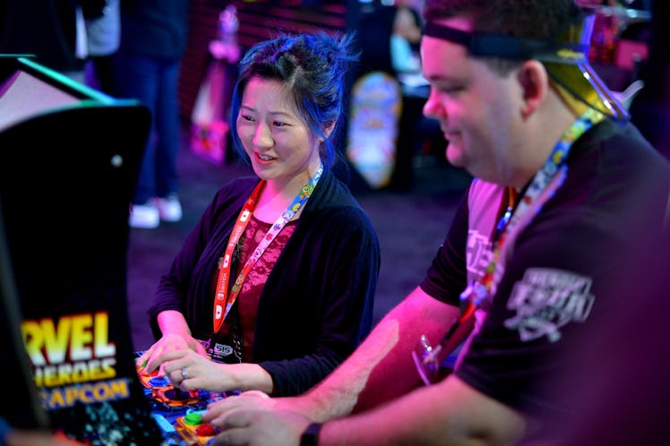 photo of two people playing arcade game at E3