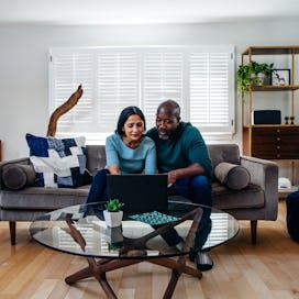 Husband and wife looking over finances in living room