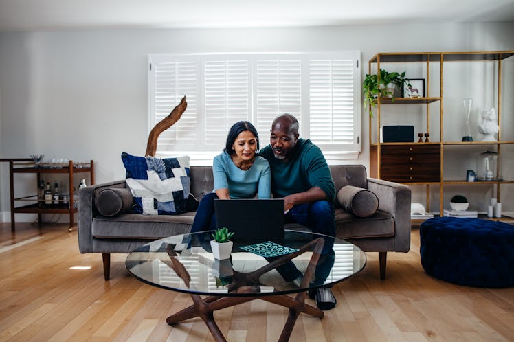 Husband and wife looking over finances in living room