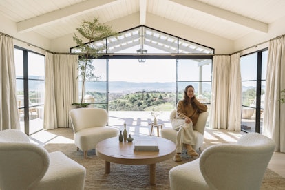 Jenni Kayne's Santa Ynez Ranch Home, living room with white chairs overlooking a body of water