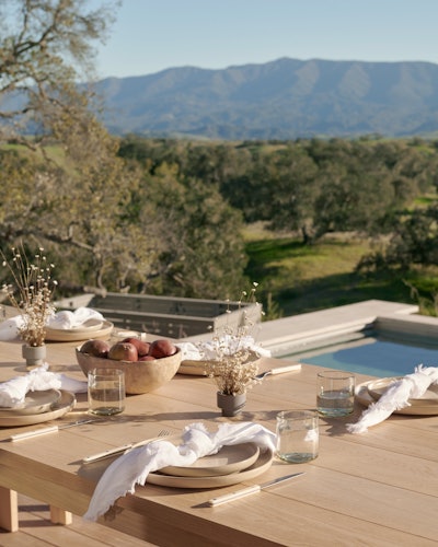 Jenni Kayne's Santa Ynez Ranch Home, a set dinner table overlooking a pool