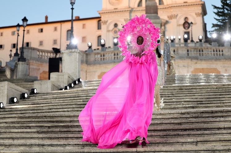 A model walking on the runway at the Valentino haute couture fall/winter 22/23 fashion show in a pur...