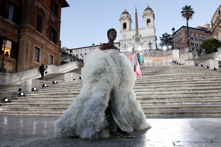 A model walking on the runway at the Valentino haute couture fall/winter 22/23 fashion show in a whi...
