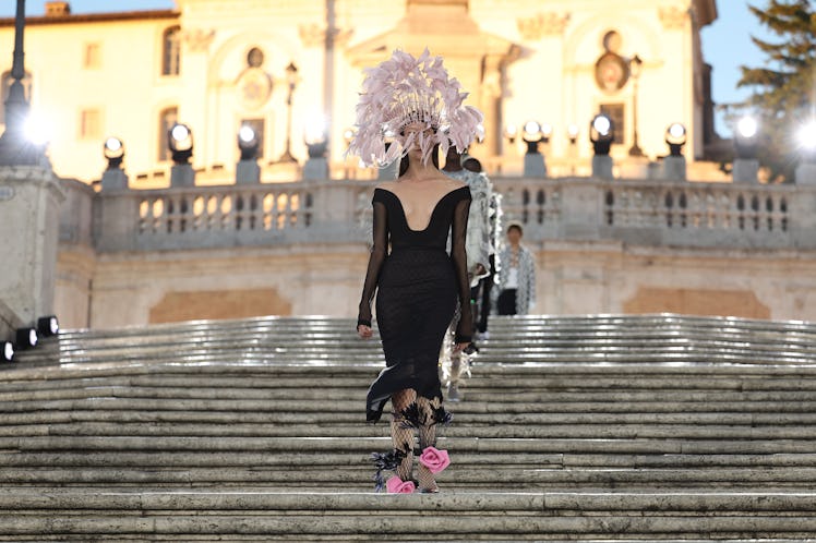 A model walking on the runway at the Valentino haute couture fall/winter 22/23 fashion show in a bla...