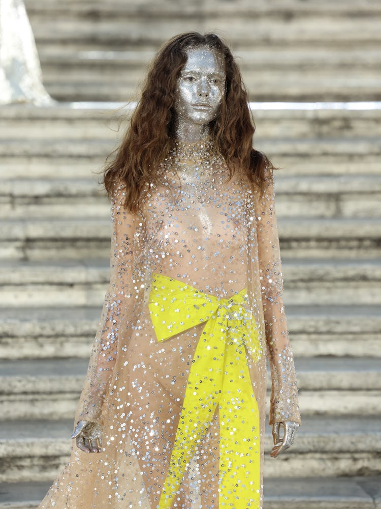 A model walking on the runway at the Valentino haute couture fall/winter 22/23 fashion show in a see...