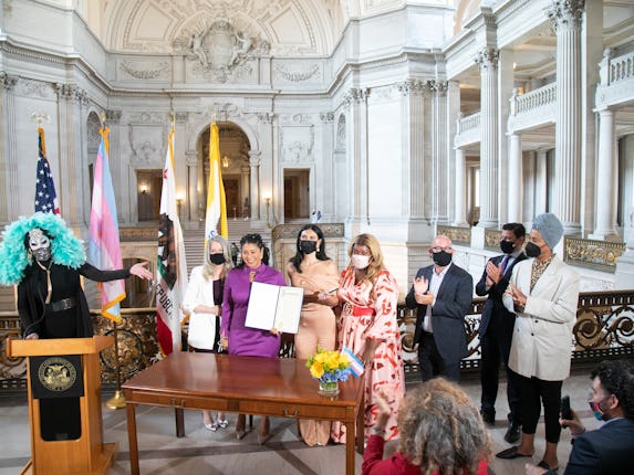 Jupiter Peraza (in beige) stands alongside Mayor London Breed (in purple) at the proclamation ceremo...