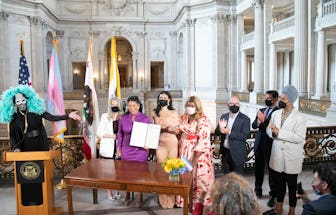 Jupiter Peraza (in beige) stands alongside Mayor London Breed (in purple) at the proclamation ceremo...