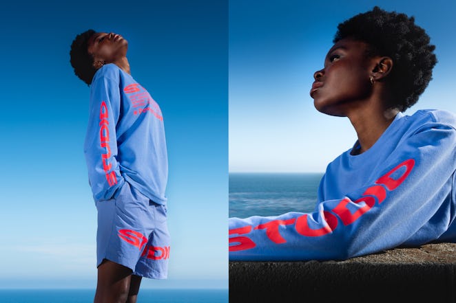 Supervsn Studios Model showing blue outfit with pink text on shirt and shorts.