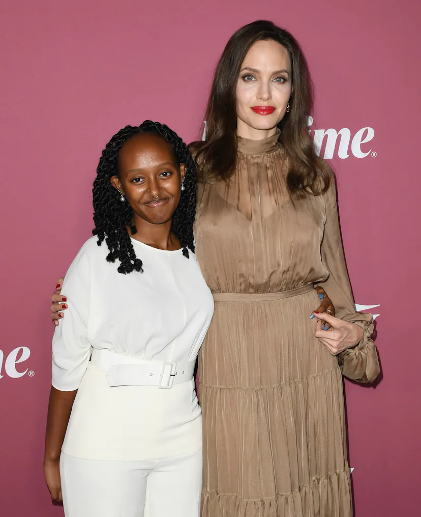 Zahara Jolie-Pitt and Angelina Jolie posing on a red carpet