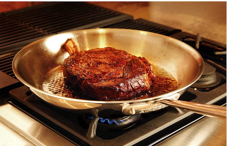 Steak cooking in an All-Clad D3 Stainless 3-ply Bonded Cookware, Fry Pan, 12 inch