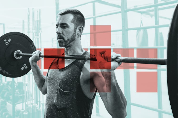 A man doing a shoulder exercise at a gym while using a barbell