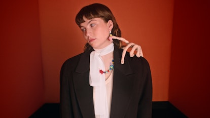 Isadora Bjarkardóttir Barney with a sculpture of a hand on her shoulder in a Miu Miu campaign 