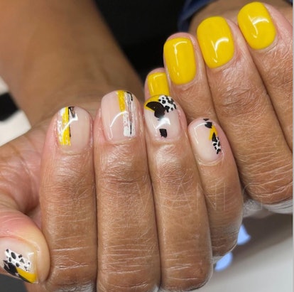 nail art, one hand with design, one hand solid yellow polish
