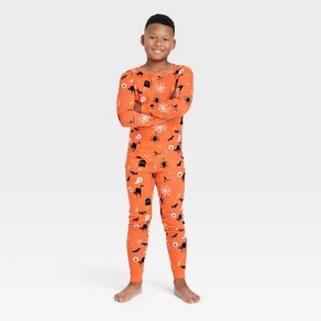 Orange and black Halloween pajamas for toddlers are perfect to wear throughout October.