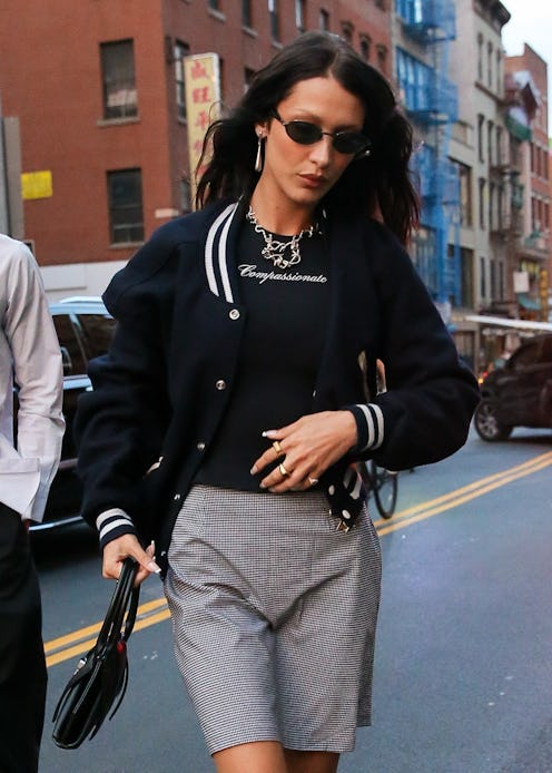 bella hadid wearing a bomber jacket and skirt in nyc on aug 9, 2022
