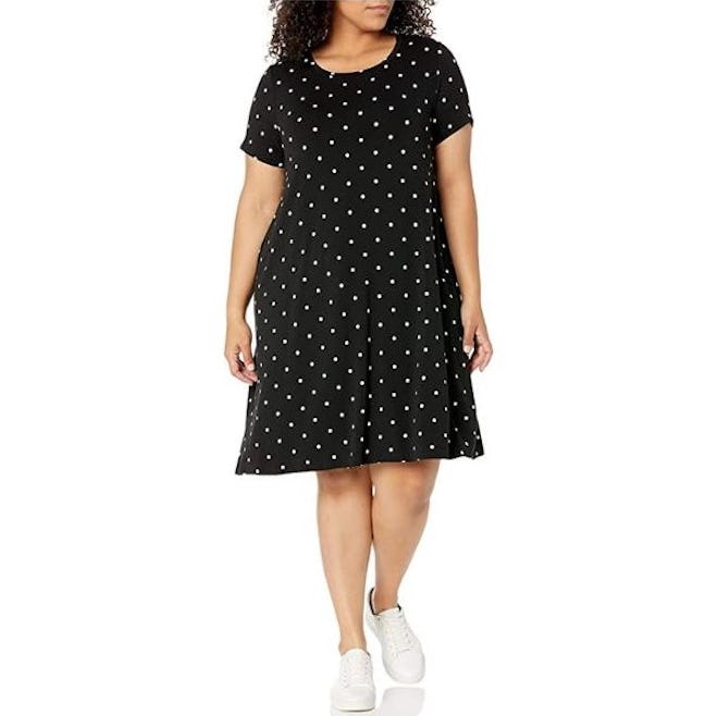 This rayon T-shirt dress features a mini hemline, short sleeves, and comes in a cute polka dot print