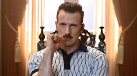 Chris Evans wearing a polo in 'The Gray Man', which he now matches with his dog, Dodger.