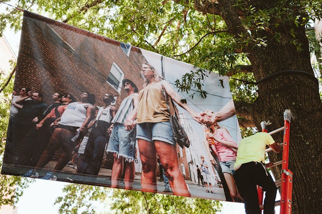 One of Amos's photos being hung for the installation in downtown Charlottesville.