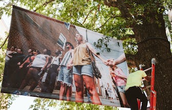 One of Amos's photos being hung for the installation in downtown Charlottesville.