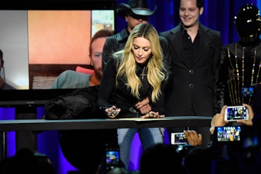 Madonna signing the Tidal constitution with her knee on the table. 