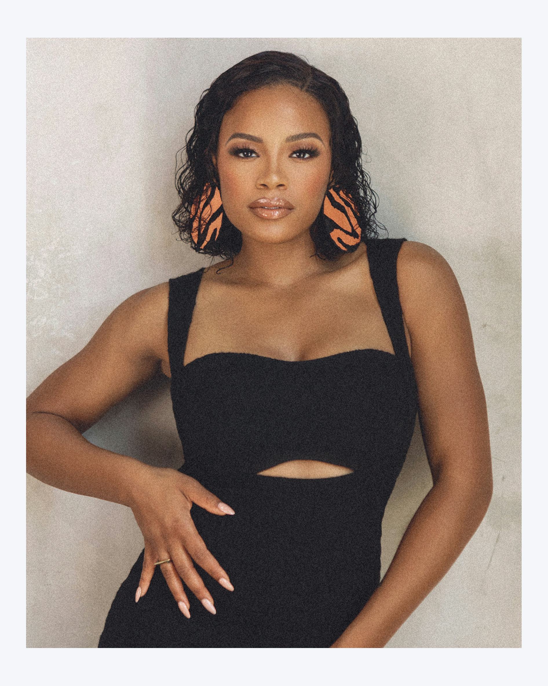 Chante Adams wearing a black dress with nude glossy lipstick