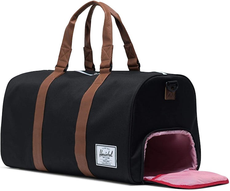 The Herschel gym bag with shoe compartment is an elevated duffel with faux leather handles.