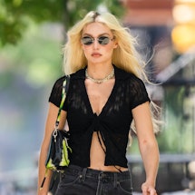 gigi hadid wearing a black crop top and jeans 
