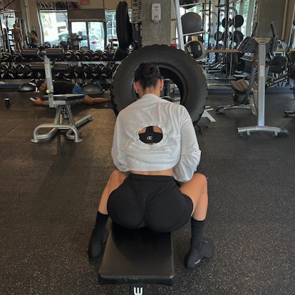 bella hadid at the gym wearing a sports bra, bike shorts, and black givenchy sneakers 