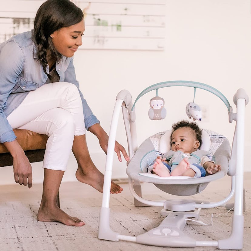 This portable baby swing has built-in toys for newborns.