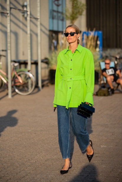 Cecilie Thorsmark seen wearing denim jeans, neon button shirt outside Rotate