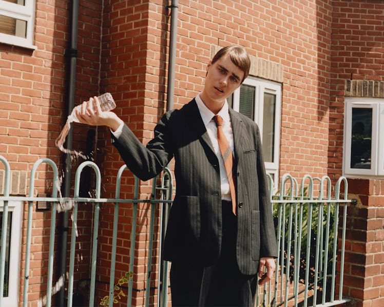 Mackenzie Davis as Stath from ‘Stath Lets Flats.’ Davis wears Margaret Howell suit, shirt, and tie.