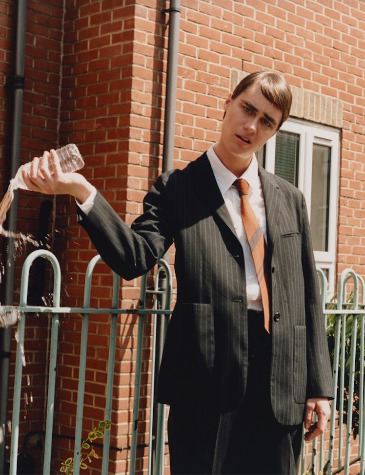 Mackenzie Davis as Stath from ‘Stath Lets Flats.’ Davis wears Margaret Howell suit, shirt, and tie.