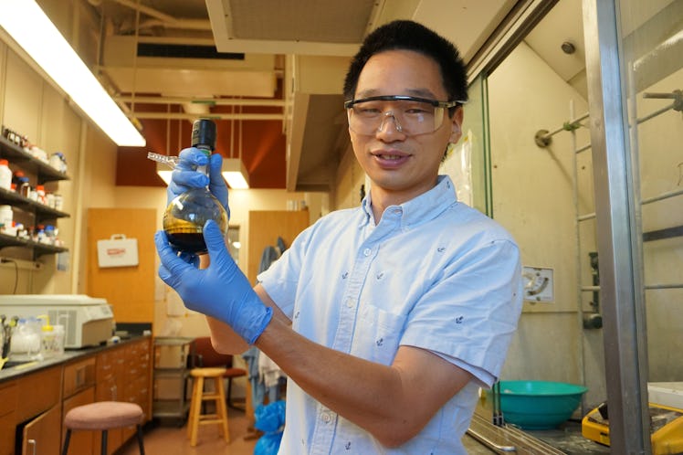The researcher holds the byproducts of degraded polystyrene, which can be turned into diphenylmethan...