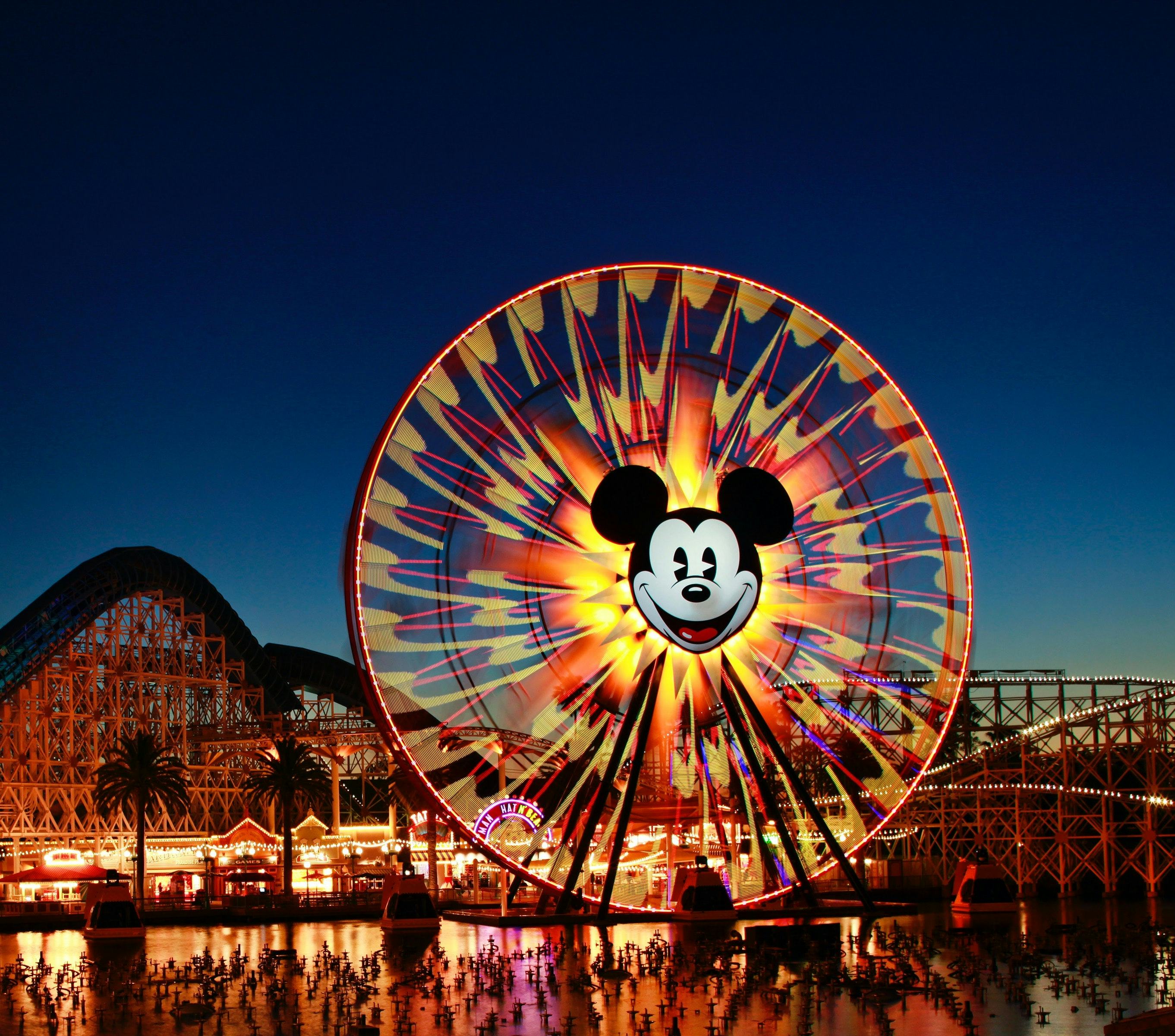 Mickey's Fun Wheel and the California Screamin' roller coaster are seen at dusk at Disney California...