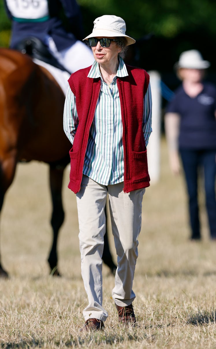 Princess Anne wearing a bucket hat and red knit vest